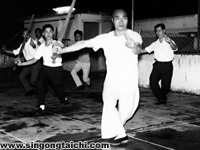 Huang (front) leads a tai chi sword form